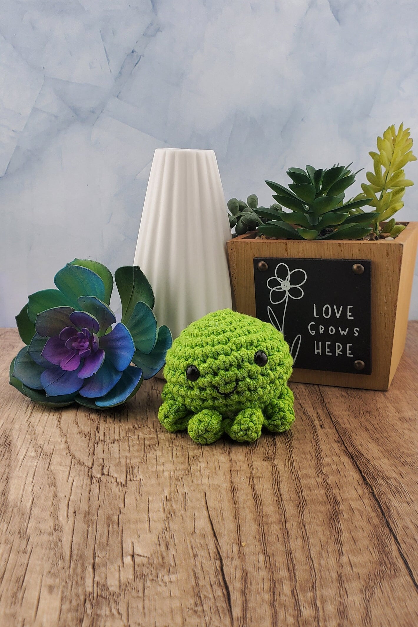 Handcrafted crocheted green Octopus buddy named Oscar.