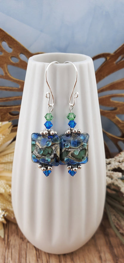 Ocean Tides Earrings, Lamp work Glass Bead handcrafted by a talented artisan, Silver Filled Earring Wire. Deep blues and greens swirl in this handcrafted glass bead.