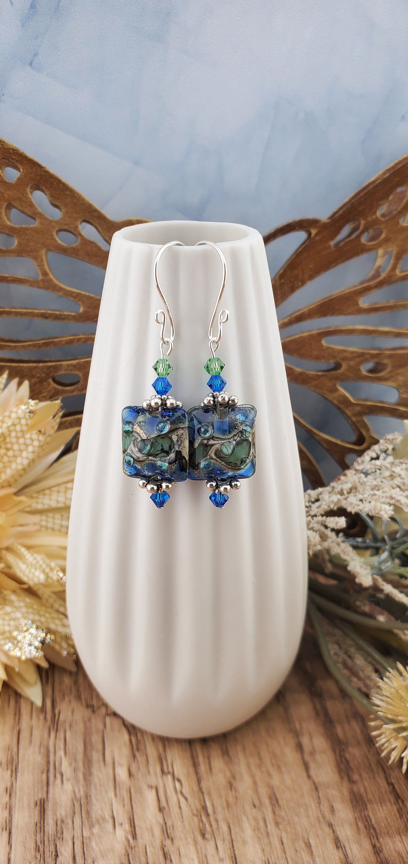 Ocean Tides Earrings, Lamp work Glass Bead handcrafted by a talented artisan, Silver Filled Earring Wire. Deep blues and greens swirl in this handcrafted glass bead.