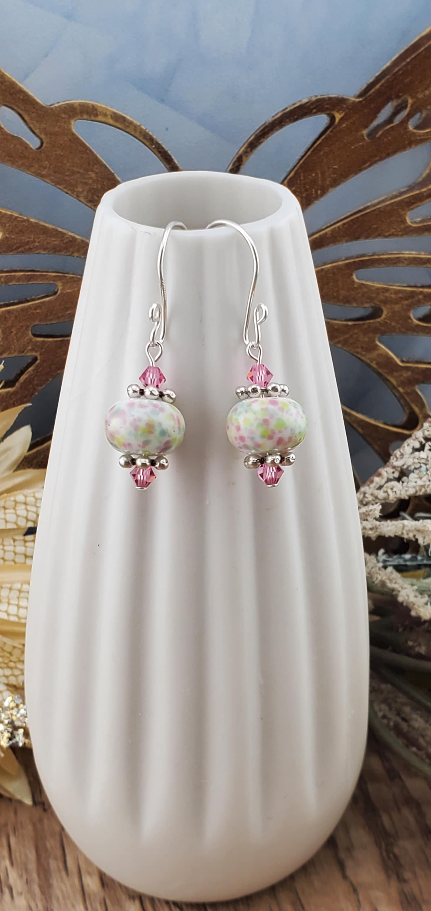 Robins egg Artisan Glass Earrings, Lampwork Glass Bead handcrafted by a talented artisan, Silver Filled Earring Wire. Lampwork beads filled with pink, green and yellow speckles complimented by pink crystal beads.