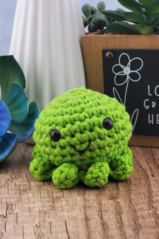 Handcrafted crocheted green Octopus buddy named Oscar.