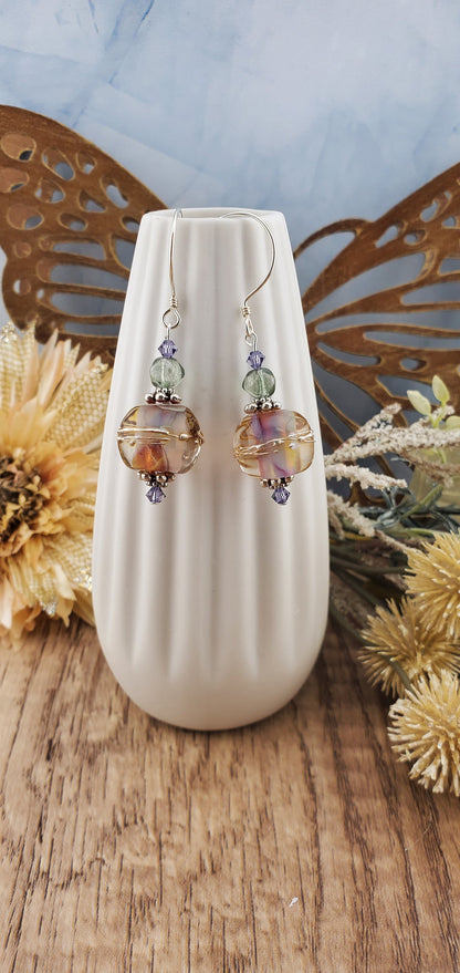 Mystical Wonders Artisan Glass Earrings, Lampwork Glass Bead handcrafted by a talented artisan, Sterling Silver Earring Wire. Shimmery purple and falls colors accented with green and purple crystal beads.