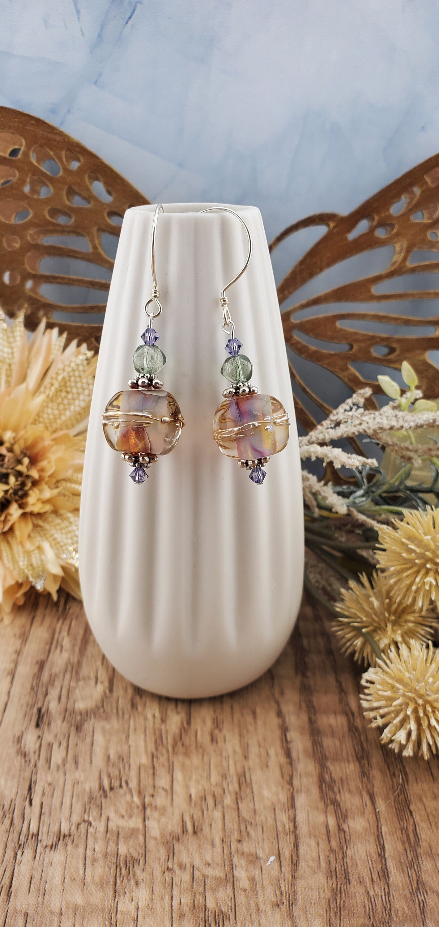 Mystical Wonders Artisan Glass Earrings, Lampwork Glass Bead handcrafted by a talented artisan, Sterling Silver Earring Wire. Shimmery purple and falls colors accented with green and purple crystal beads.