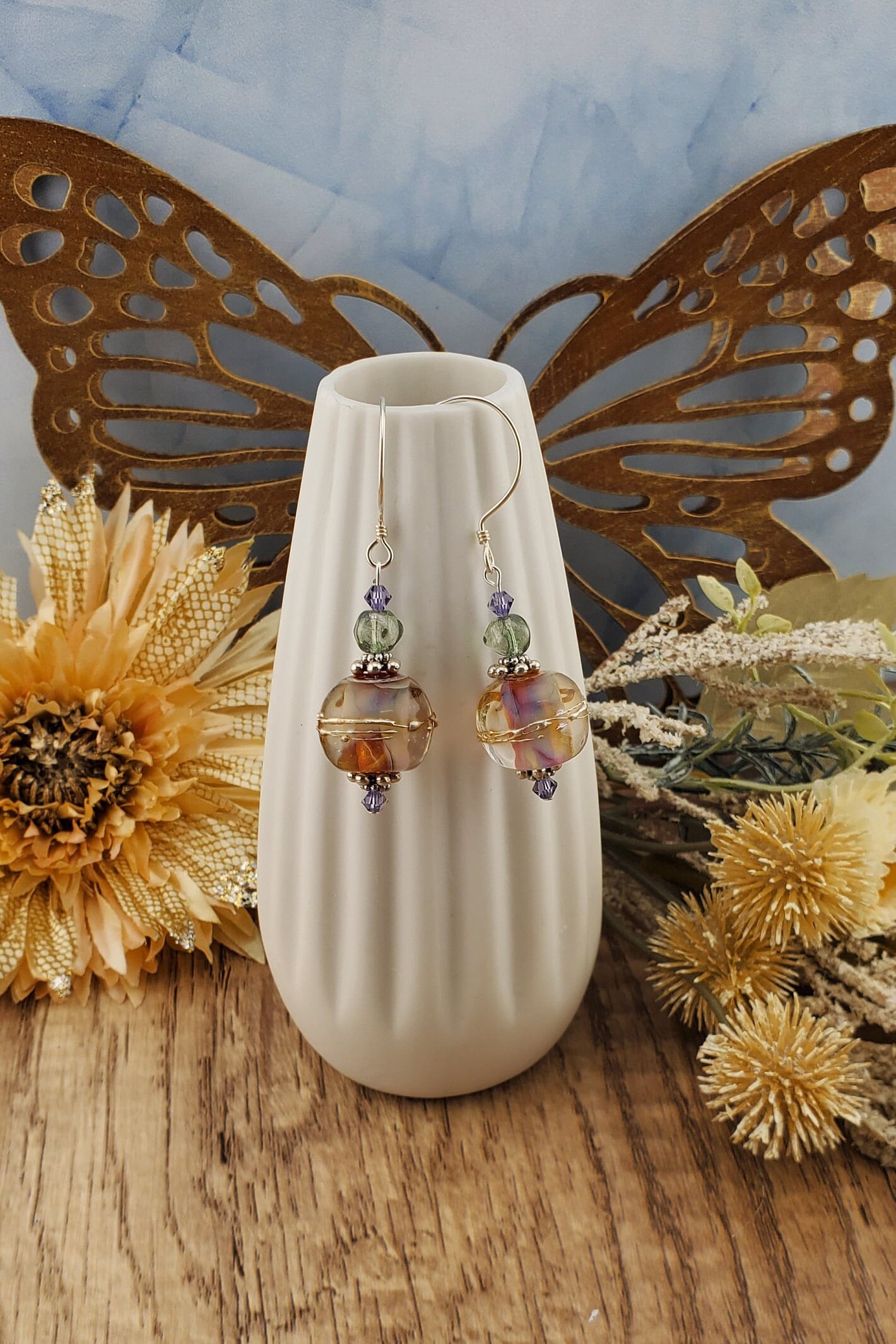 Mystical Wonders Artisan Glass Earrings, Lampwork Glass Bead handcrafted by a talented artisan, Sterling Silver Earring Wire. Shimmery purple and falls colors accented with green and purple crystal beads.