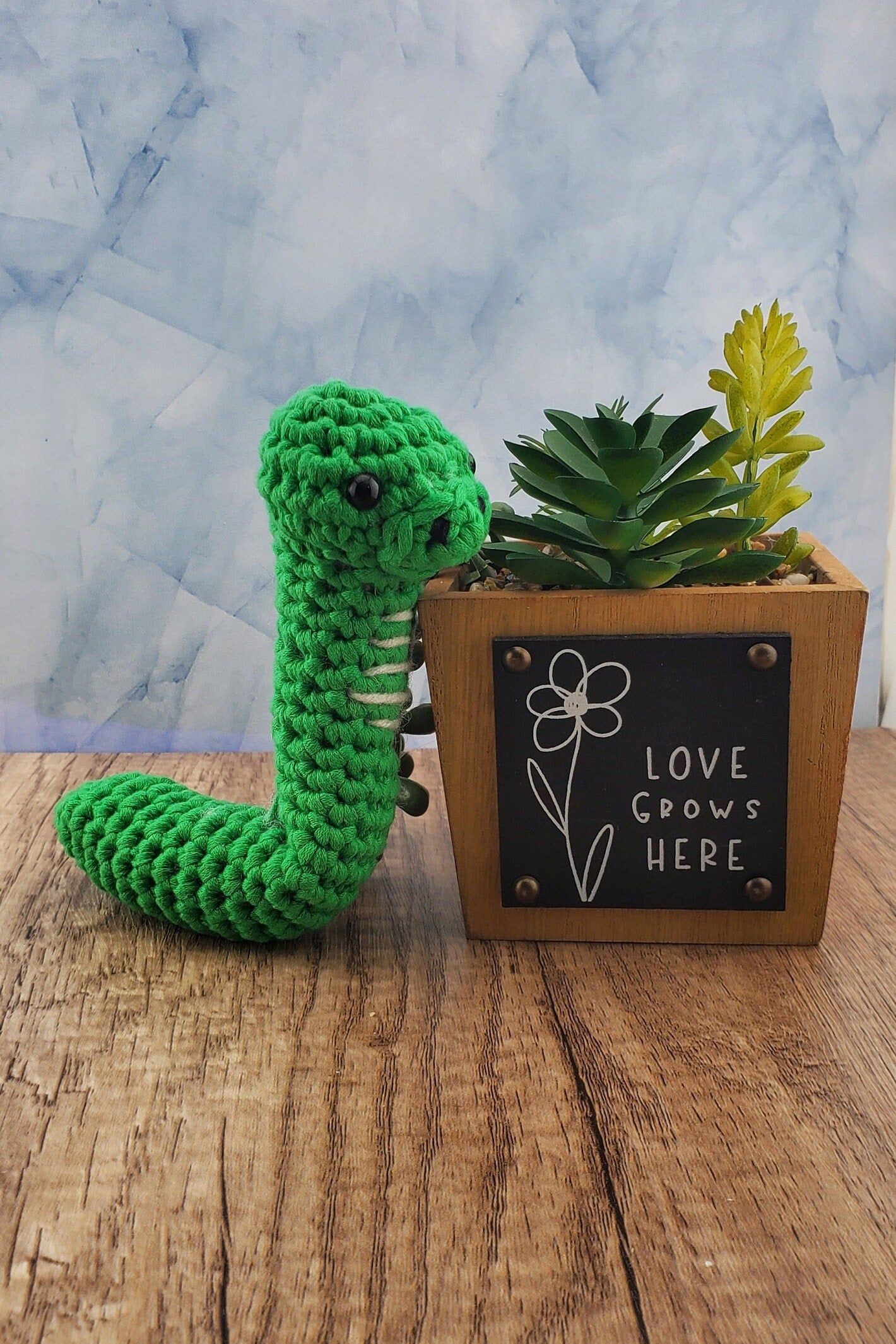 Handcrafted crocheted green Snake buddy named Sssage.