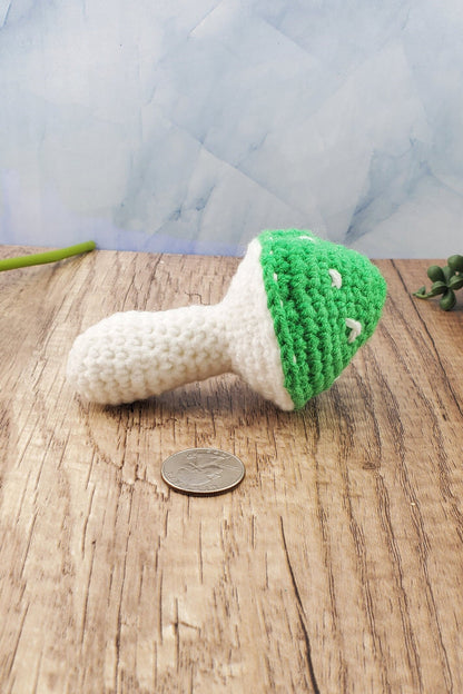 Handcrafted crocheted mushroom buddy named Miles. White and green mushroom with white spots.