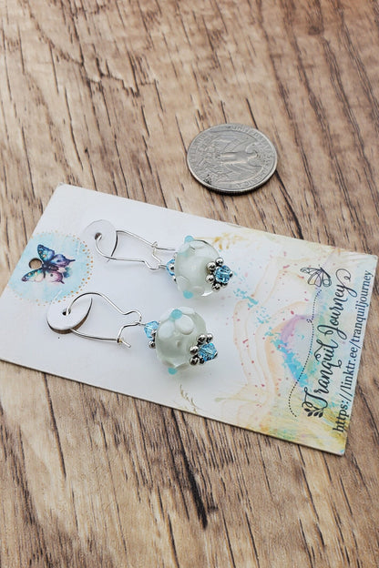 SF Baby Blue Blossoms. Artisan Glass Earrings, Lampwork Glass Bead handcrafted by a talented artisan, Silver Filled Earring Wire. White floral lampwork glass bead with baby blue accents.