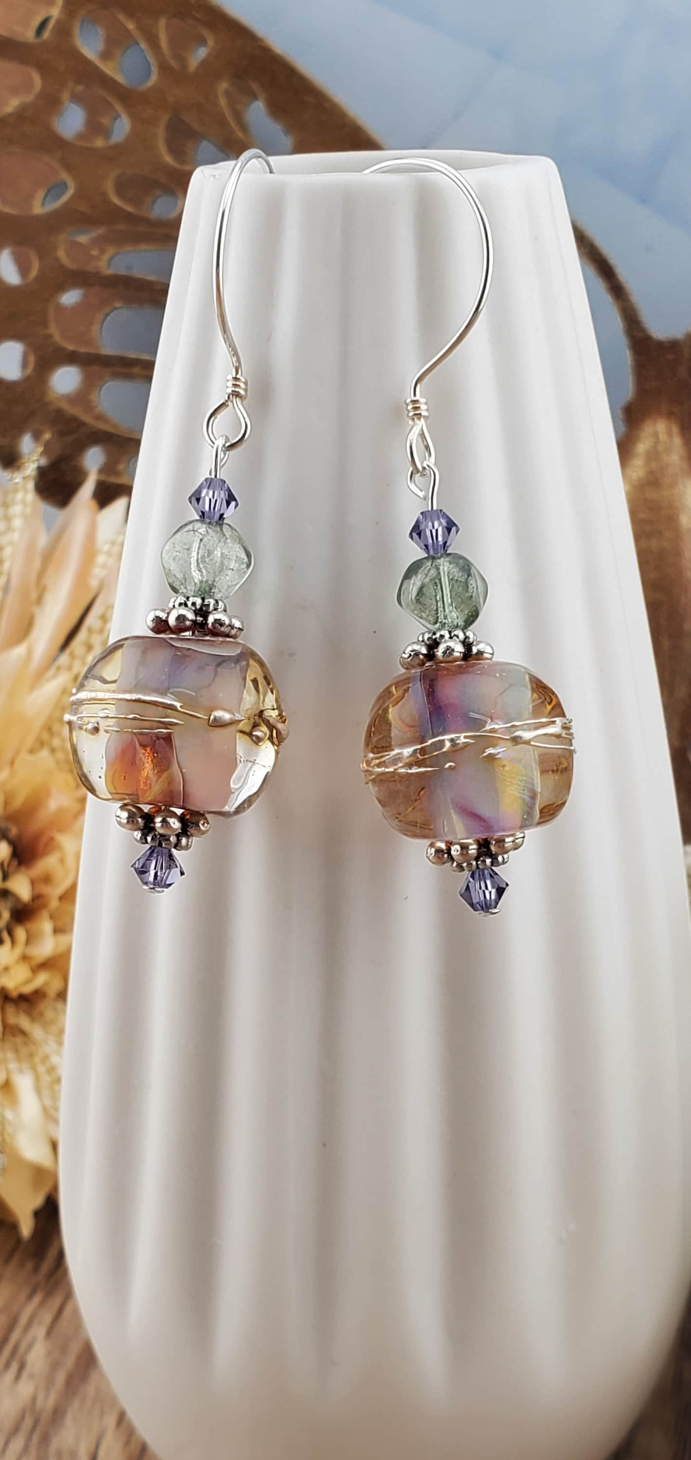 Mystical Wonders Artisan Glass Earrings, Lampwork Glass Bead handcrafted by a talented artisan, Sterling Silver Earring Wire. Shimmery purple and falls colors accented with green and purple crystal beads.