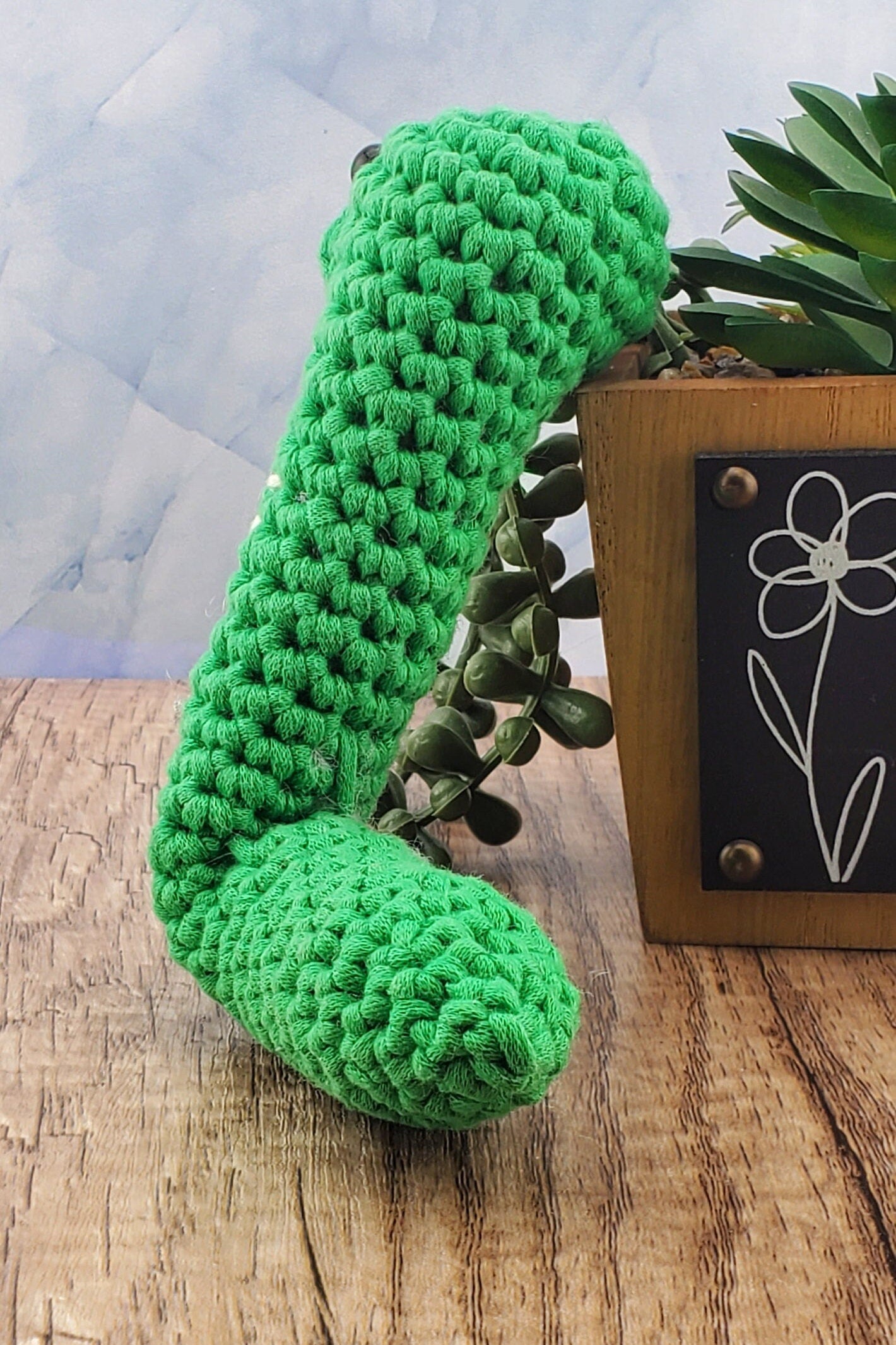 Handcrafted crocheted green Snake buddy named Sssage.