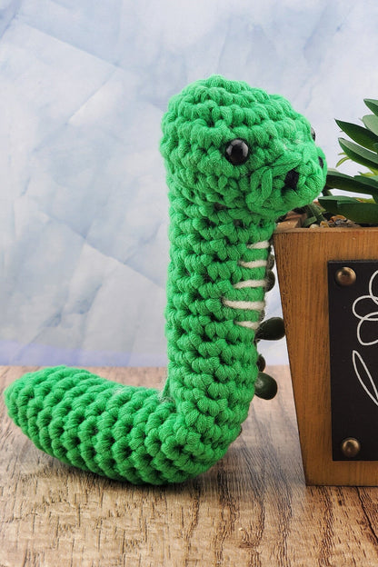 Handcrafted crocheted green Snake buddy named Sssage.