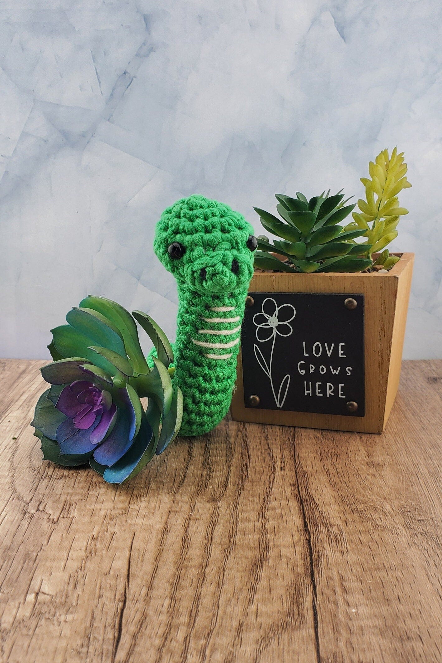 Handcrafted crocheted green Snake buddy named Sssage.