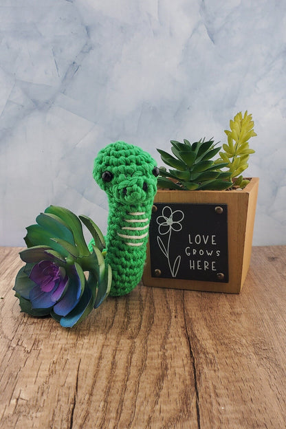 Handcrafted crocheted green Snake buddy named Sssage.