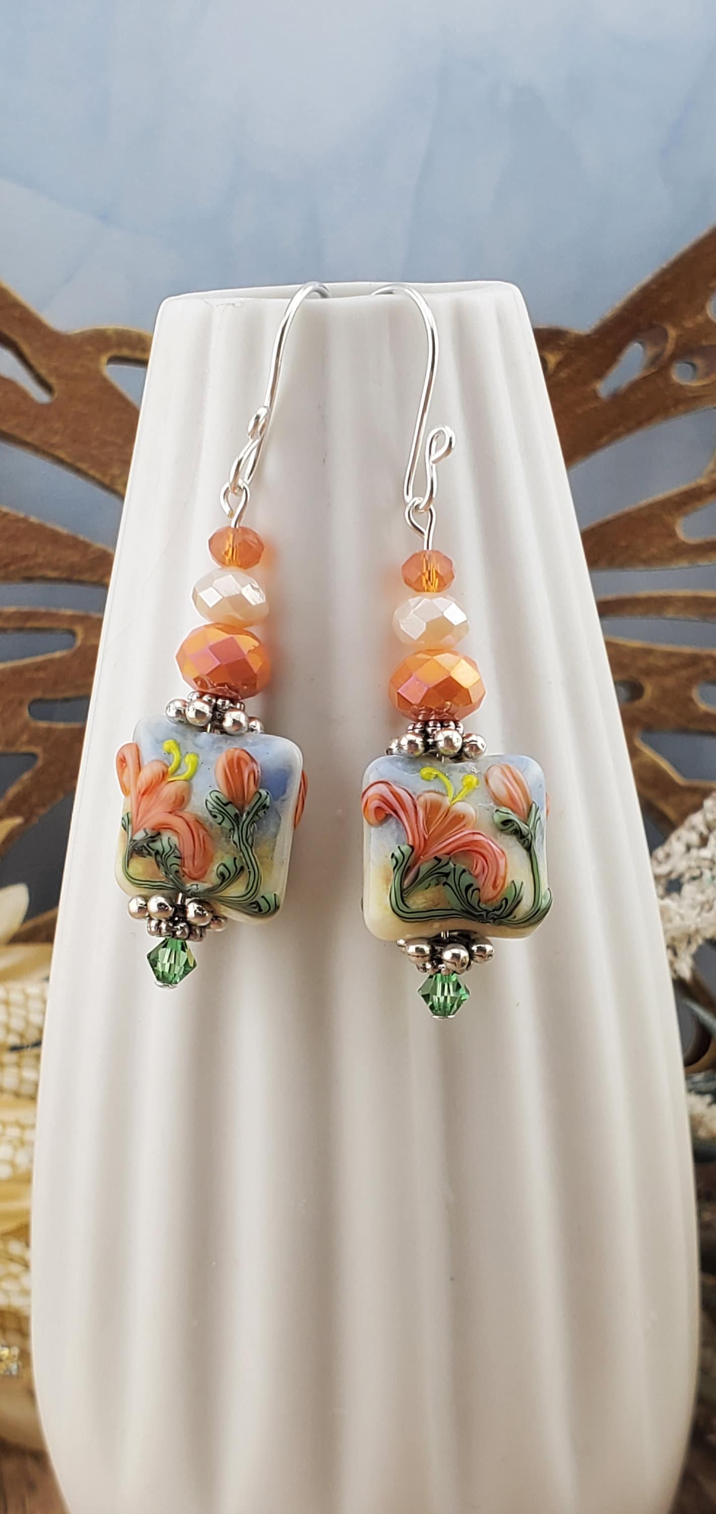 Floral Bliss Artisan Glass Earrings, Lampwork Glass Bead by Grace Lampwork Beads, Sterling Silver Earring Wire. Orange, peach and green floral colors.