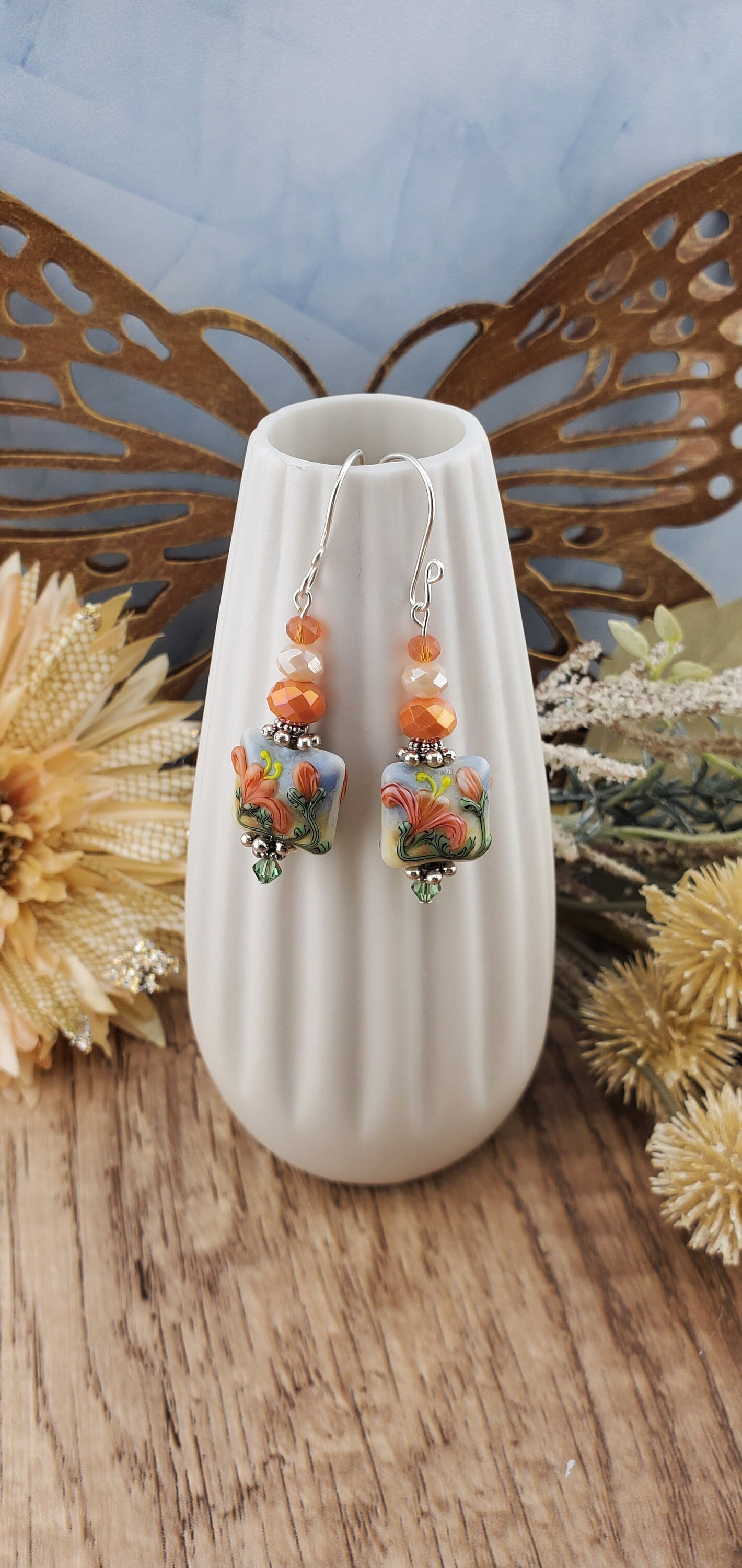 Floral Bliss Artisan Glass Earrings, Lampwork Glass Bead by Grace Lampwork Beads, Sterling Silver Earring Wire. Orange, peach and green floral colors.