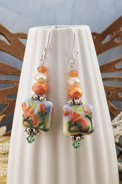 Floral Bliss Artisan Glass Earrings, Lampwork Glass Bead by Grace Lampwork Beads, Sterling Silver Earring Wire. Orange, peach and green floral colors.