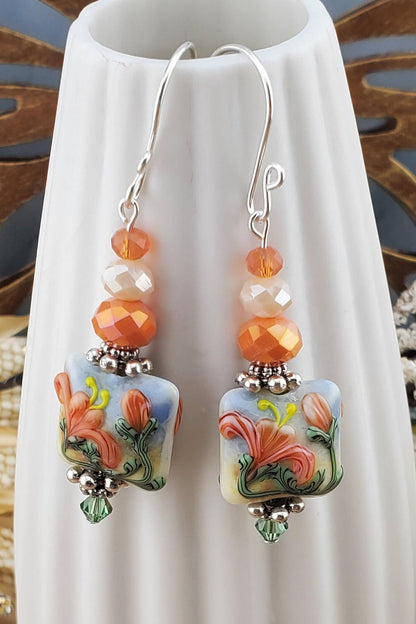 Floral Bliss Artisan Glass Earrings, Lampwork Glass Bead by Grace Lampwork Beads, Sterling Silver Earring Wire. Orange, peach and green floral colors.