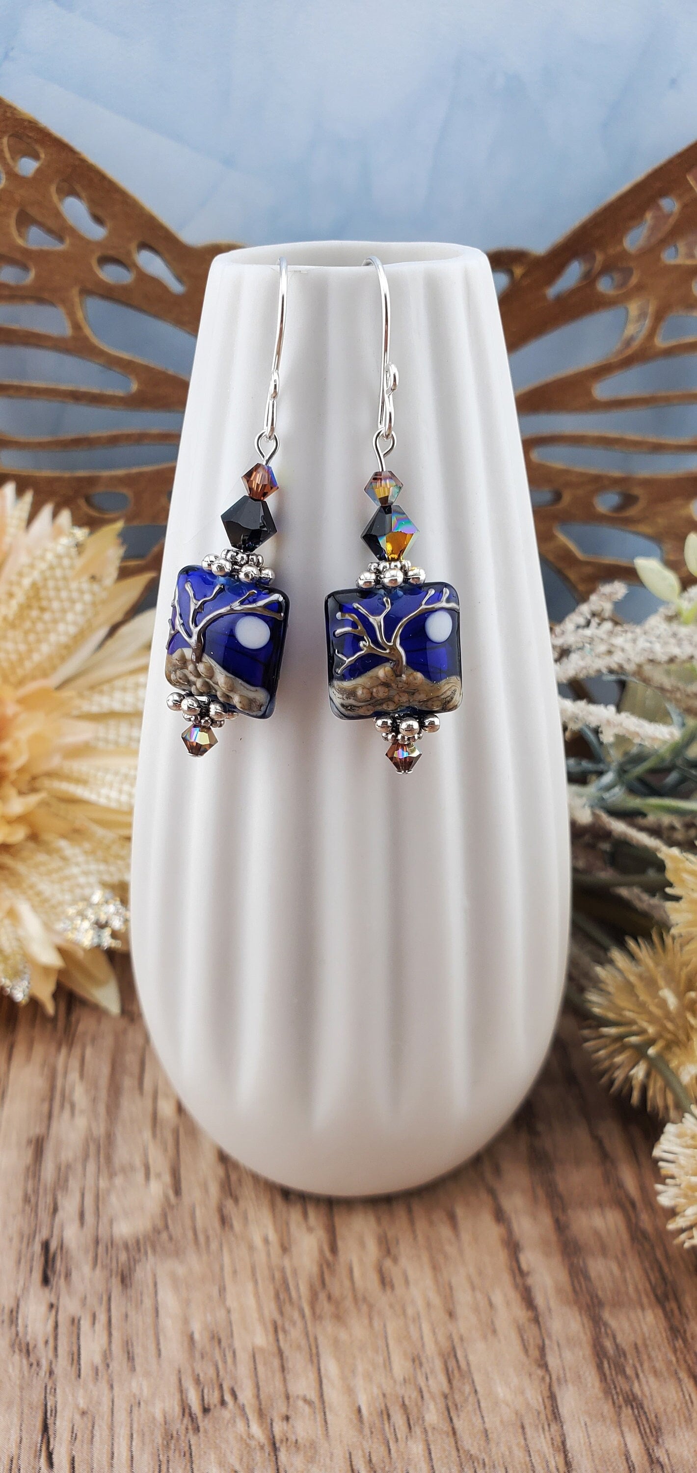 Cobalt Sky Earrings, Lamp work Glass Bead handcrafted by a talented artisan, Sterling Silver Earring Wire. Cobalt blue bead with copper tree in the foreground and a full moon.