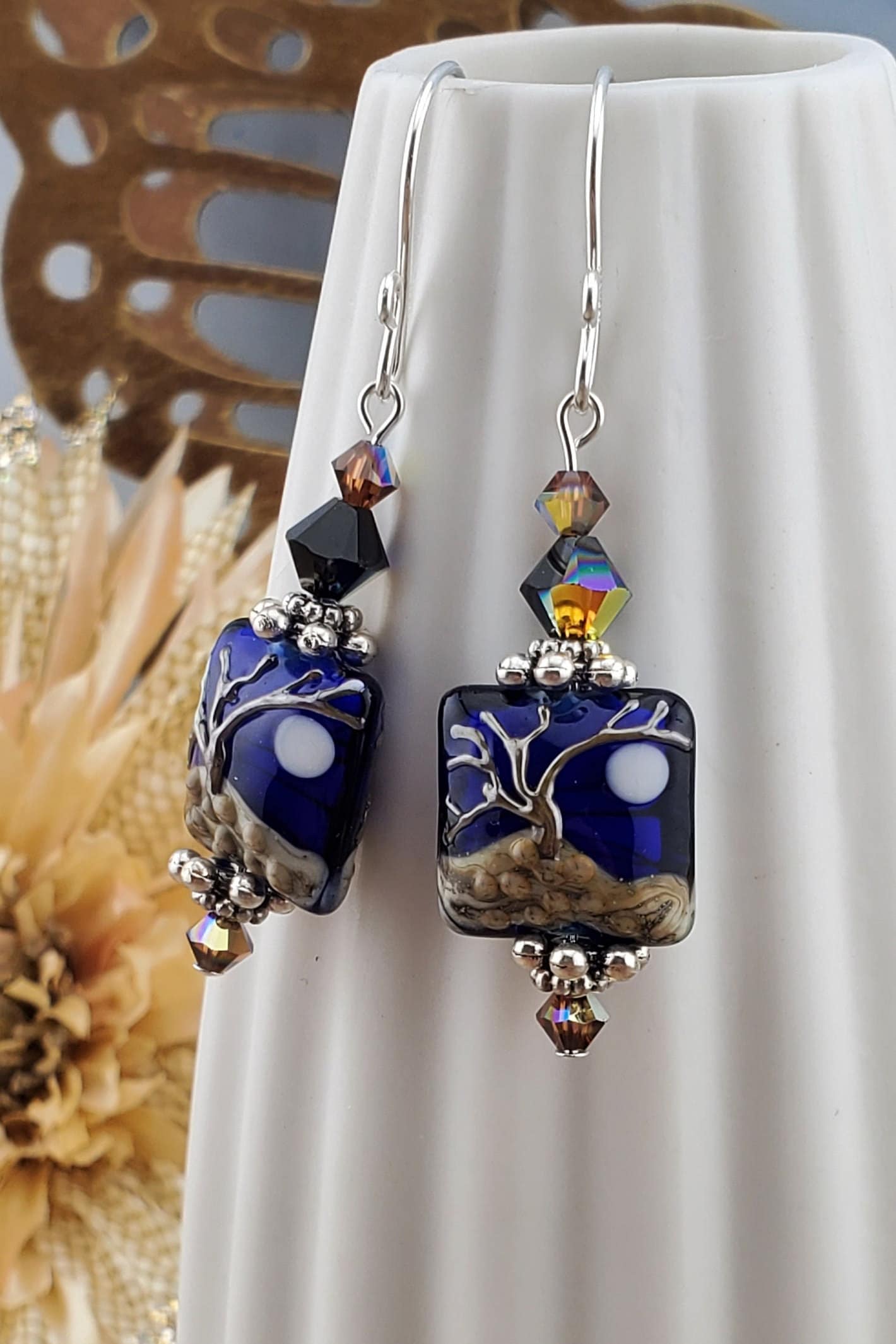 Cobalt Sky Earrings, Lamp work Glass Bead handcrafted by a talented artisan, Sterling Silver Earring Wire. Cobalt blue bead with copper tree in the foreground and a full moon.