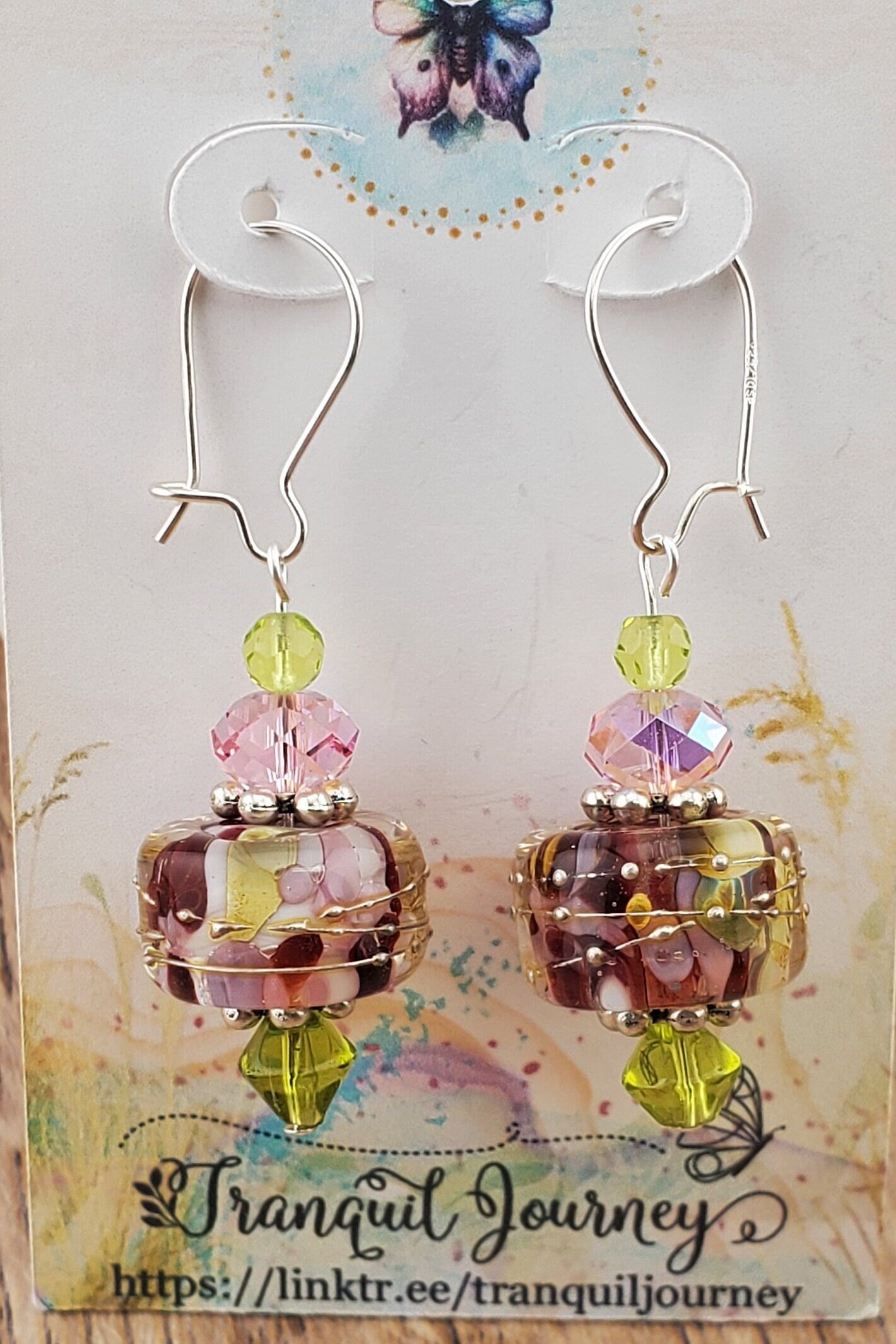 SF Springtime Whispers Artisan Glass Earrings, Lampwork Glass Bead handcrafted by a talented artisan, Silver Filled Earring Wire. Pink and Green swirls with golden accents make this lampwork glass bead. It is accented with pink and green crystals.