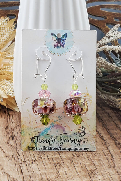 SF Springtime Whispers Artisan Glass Earrings, Lampwork Glass Bead handcrafted by a talented artisan, Silver Filled Earring Wire. Pink and Green swirls with golden accents make this lampwork glass bead. It is accented with pink and green crystals.