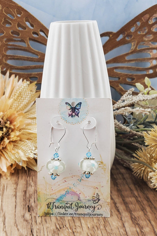 SF Baby Blue Blossoms. Artisan Glass Earrings, Lampwork Glass Bead handcrafted by a talented artisan, Silver Filled Earring Wire. White floral lampwork glass bead with baby blue accents.