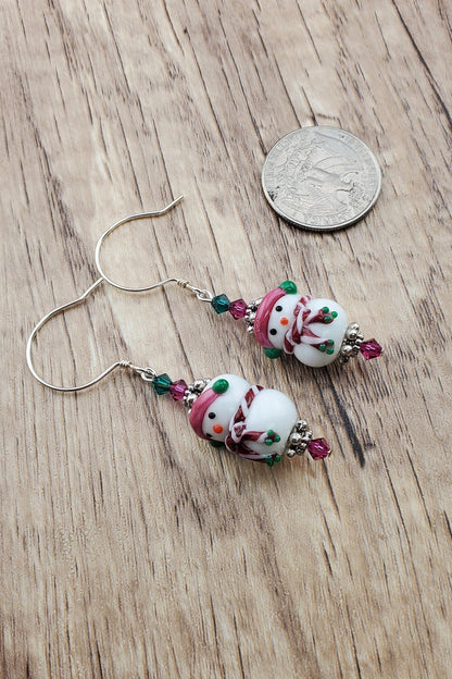 SS Blushing Snow Buddy Artisan Glass Earrings, Sterling Silver Earring Wire. Snowman with a pink scarf and green and pink crystal beads accenting the lampwork bead.