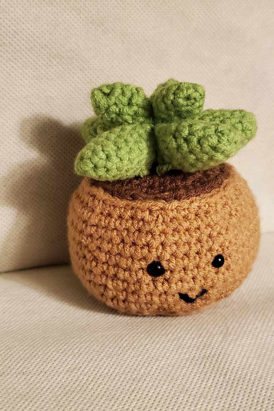 Handcrafted crochet succulent in a brown crochet pot.